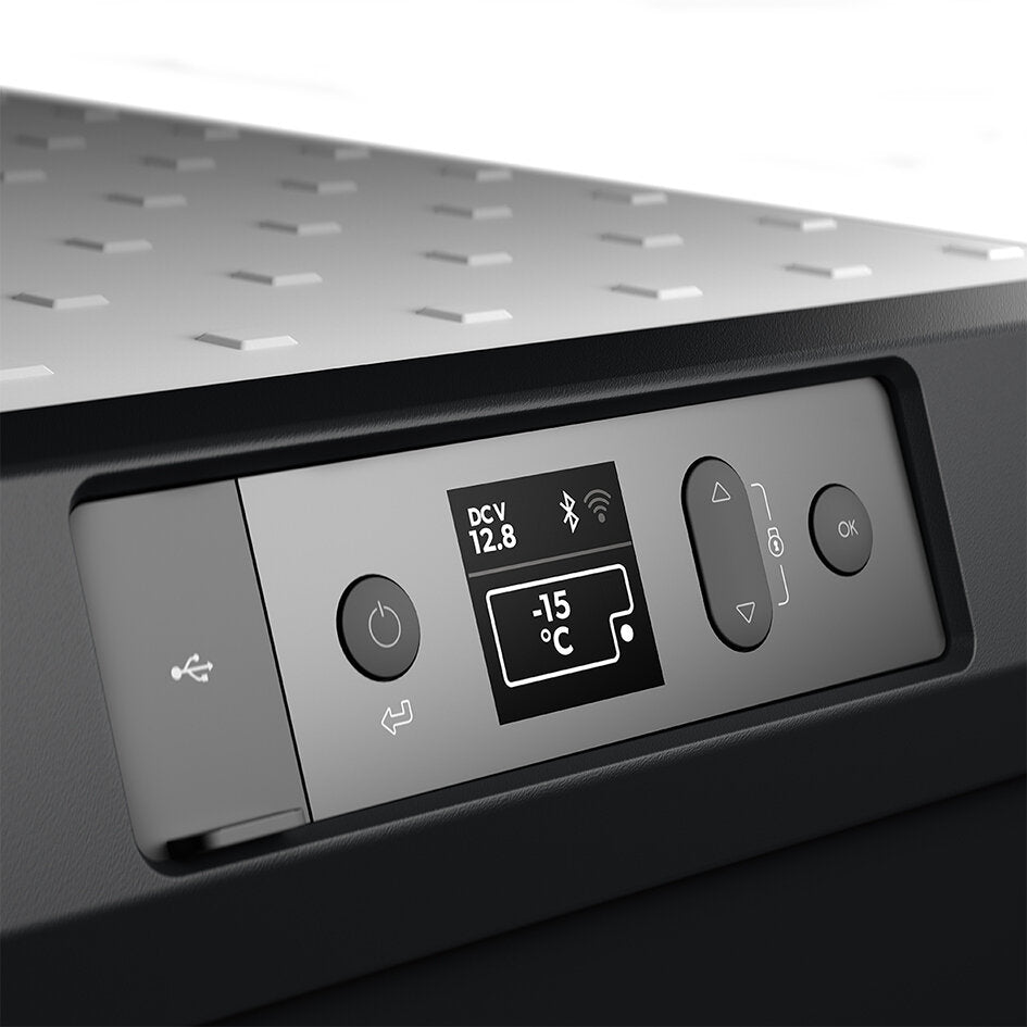 Bedienfeld einer Kühlbox CoolFreeze CFX3 55IM mit Display; zeigt -15 °C, DCV 12.8 und Bluetooth- sowie WLAN-Symbole, sowie linke und rechte Knöpfe