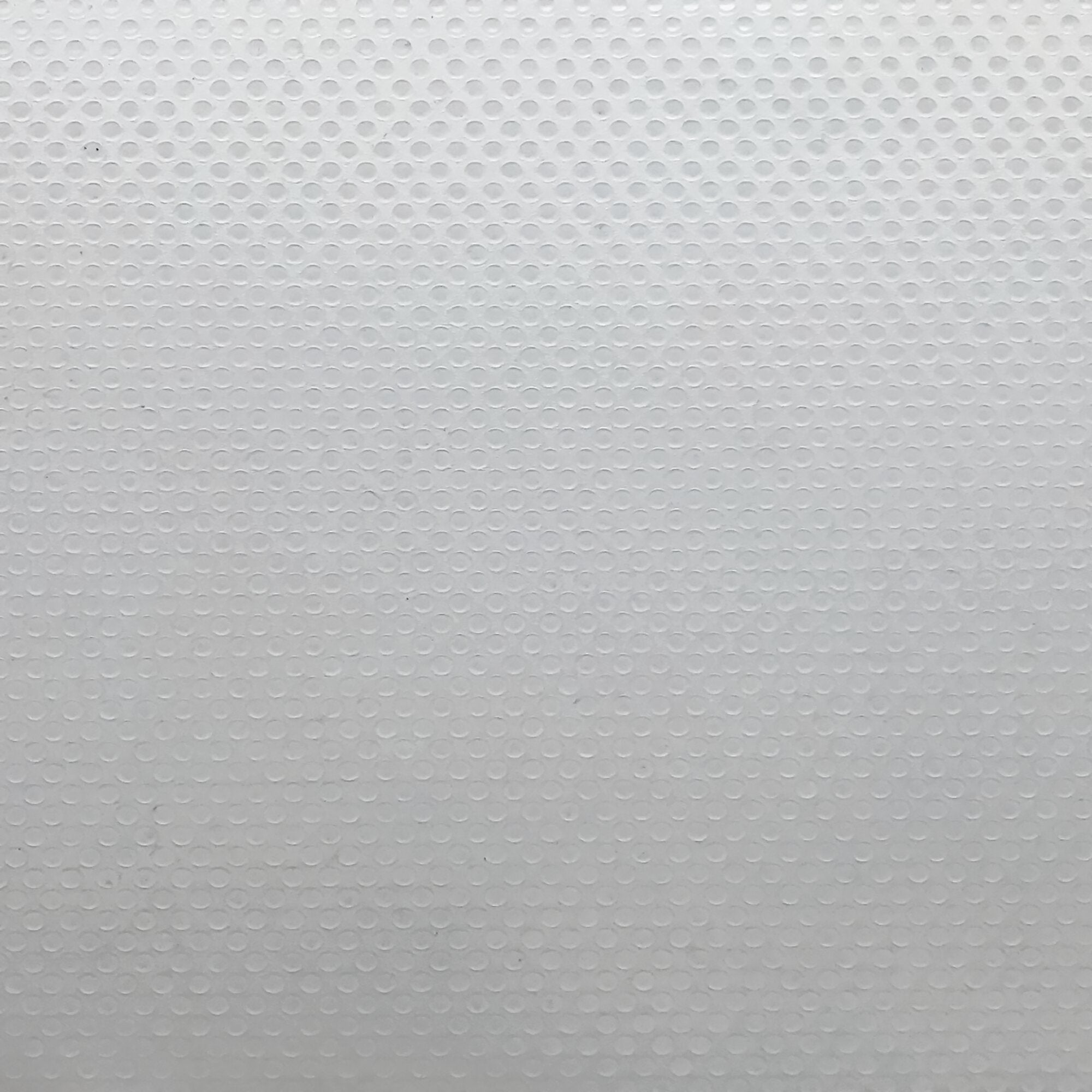 Nahezu weiße Oberfläche mit regelmäßig angeordneten kleinen runden Noppen, Textur einer Antirutschfolie