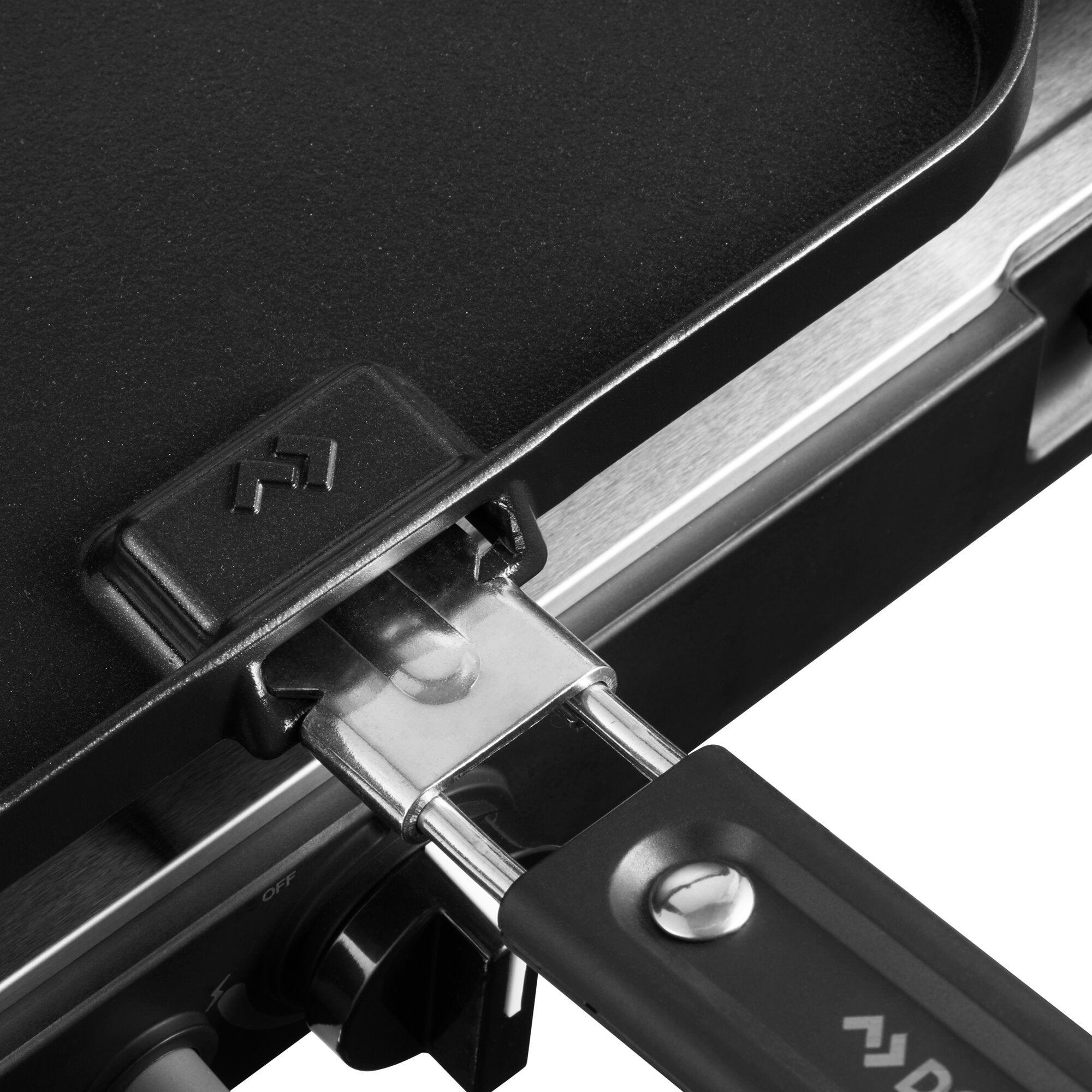 Detailaufnahme eines Gaskochers mit schwarzer texturierter Kochfläche, silbernem Metallrahmen und einem runden Bedienelement mit OFF-Markierung