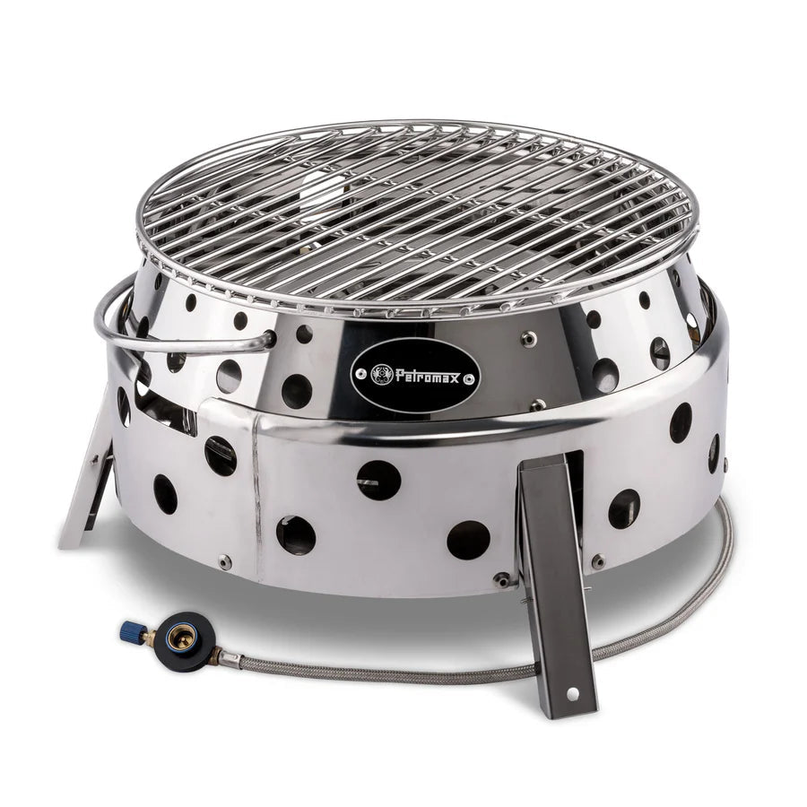 Runder Petromax Atago Gasgrill aus glänzendem Edelstahl mit Lüftungslöchern und abnehmbarem Grillrost, kompakt und stabil.